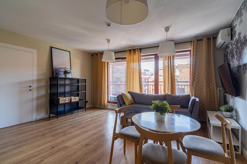 a living room with a couch and a table at SPA Waterlane Island Deluxe 1 by Grand Apartments in Gdańsk