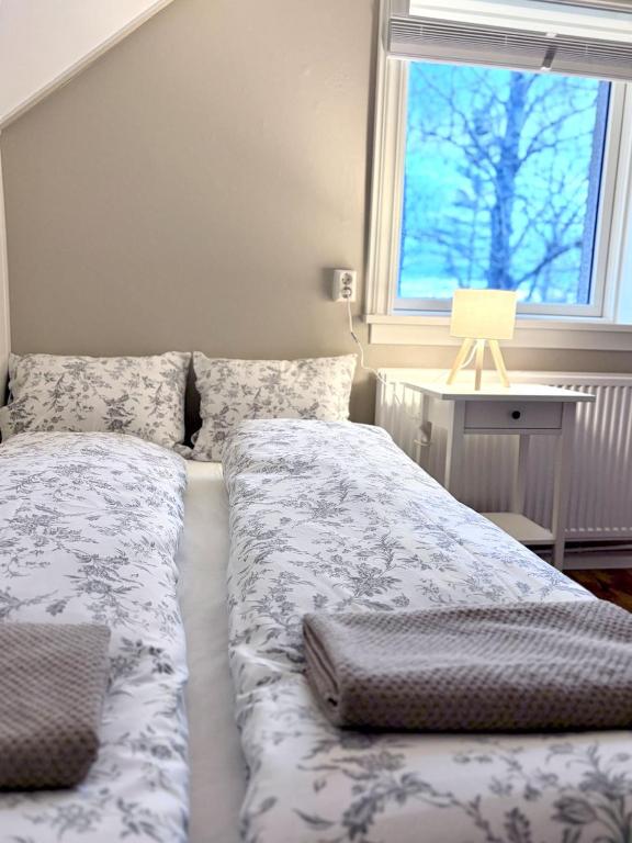 a bed sitting in a bedroom with a window at Eldstó Art Café Guesthouse in Hvolsvöllur