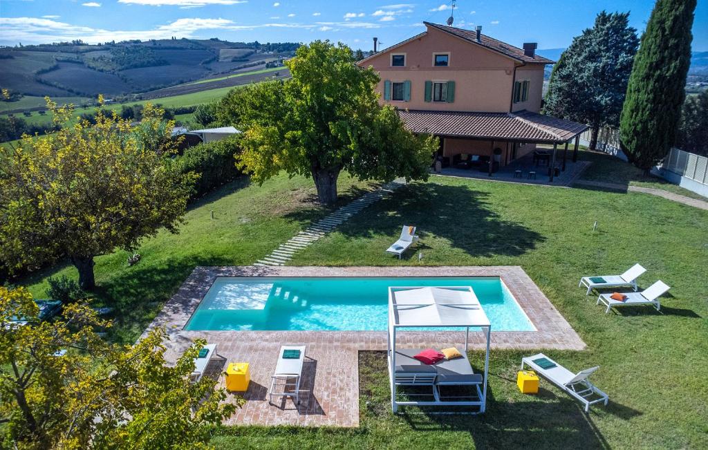 an external view of a villa with a swimming pool at Villa Traiani 8&2 by Marche Holiday Villas in Piagge