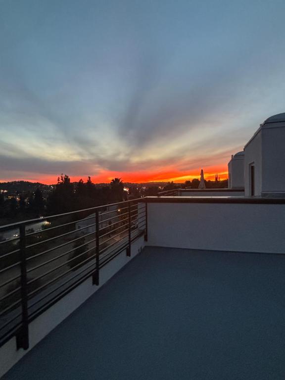 a view of a sunset from the balcony of a building at Luxe Home Near DTLA & Dodgers with Rooftop in Los Angeles