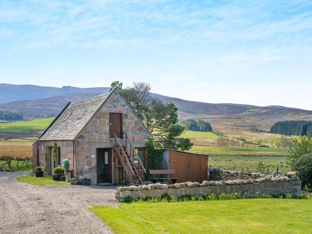 a small stone house on the side of a road at Ben View in Aberlour