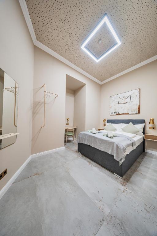 a bedroom with a large bed in a white room at District One - Hideaway Hostel in Vienna