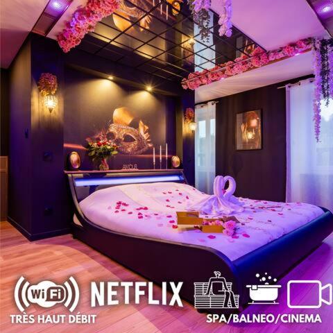 a room with a purple bed with a cake on it at La prestigieuse Sauna Balnéo Ciné in Roannes-Saint-Mary