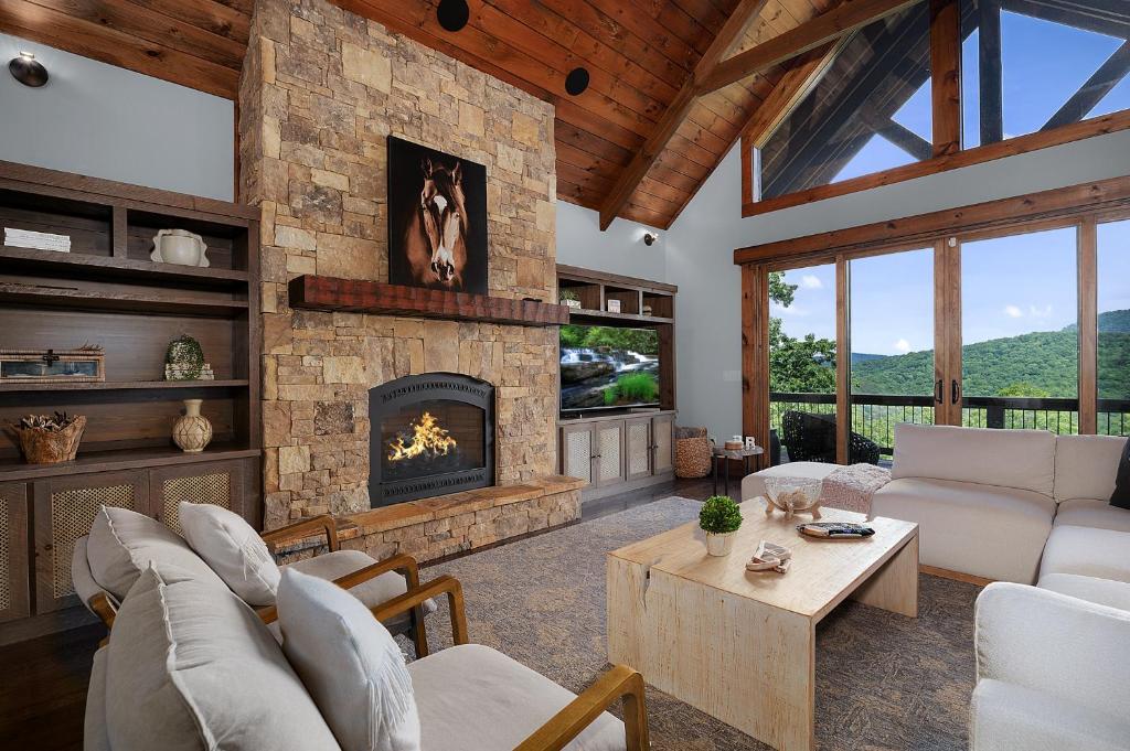 ein Wohnzimmer mit einem großen Steinkamin in der Unterkunft Morning Glow - Luxury Mountain Cabin in Blue Ridge in Ballew Mill
