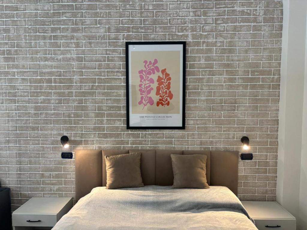 a bedroom with a bed and a brick wall at Typic loft Alghero in Alghero