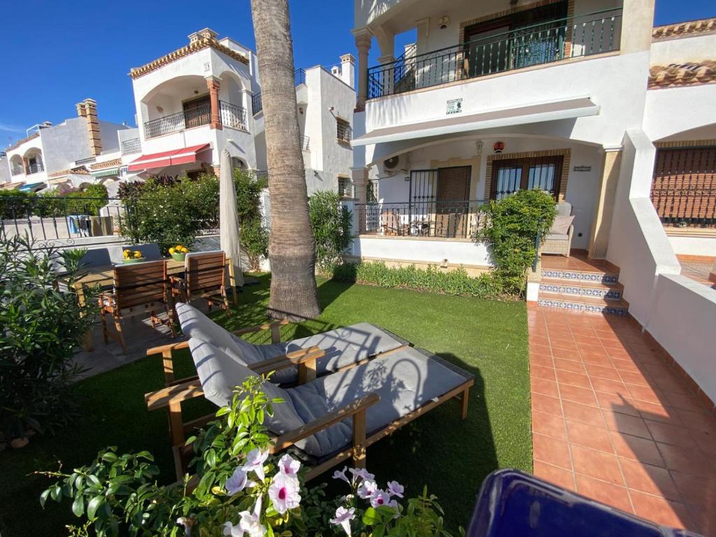 a patio with a table and chairs in front of a house at Casa Kessing in Orihuela Costa