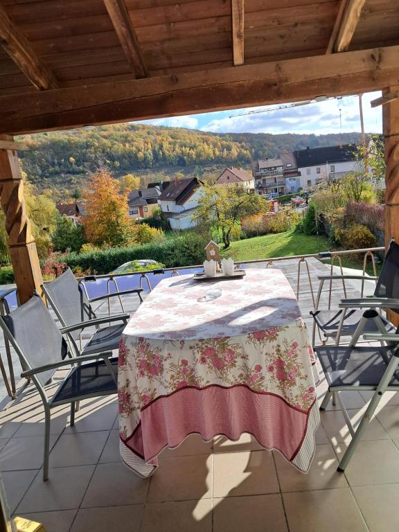 a table and chairs on a patio with a view at Fewo Kastel in Nonnweiler
