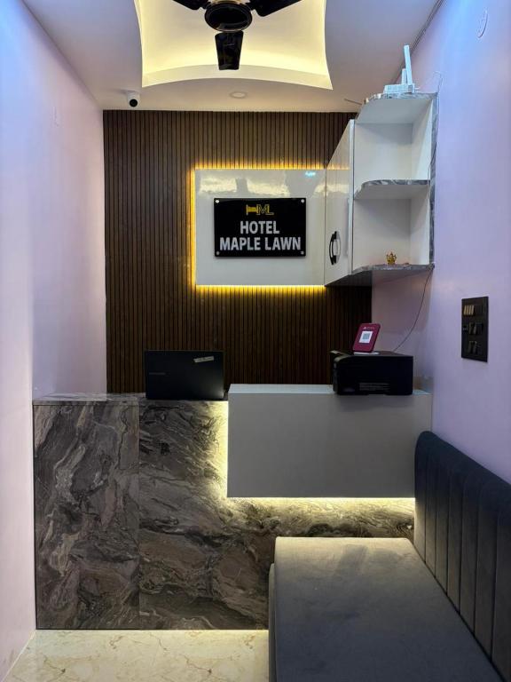 a lobby of a hotel make laws sign on a wall at Hotel Maple Lawn in Guwahati