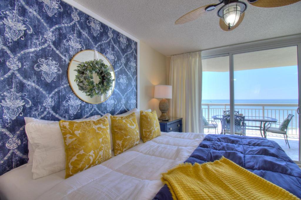a bedroom with a bed with a view of the ocean at Crescent Shores South - 612 in Myrtle Beach