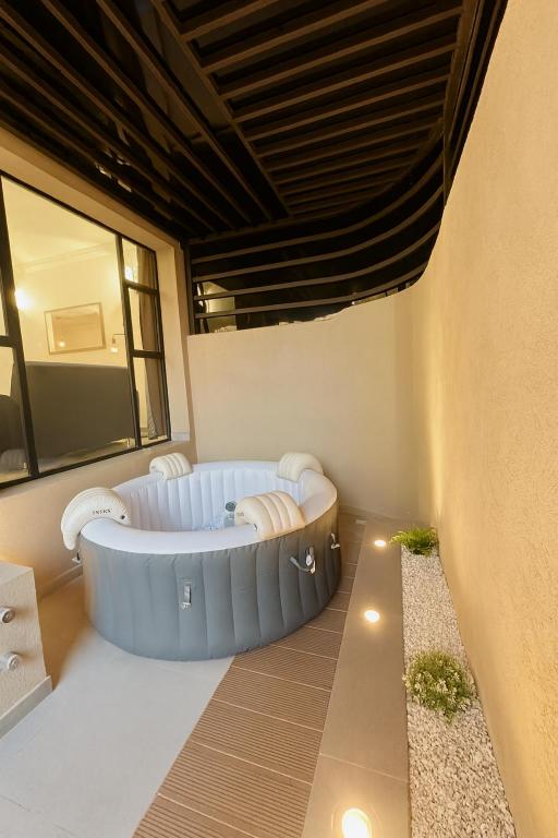 a wellness room with a bathtub in the middle of a building at Sublime Appartement Marrakech in Marrakech