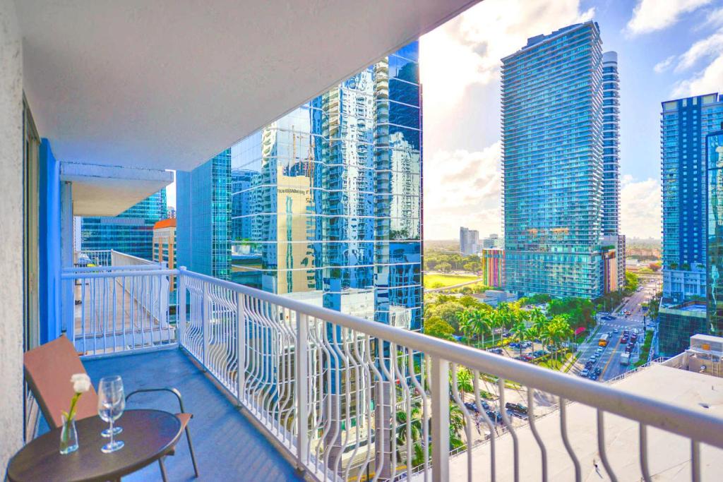 a balcony with a table and a view of a city at Bright & Modern Condo in Brickell w Pool Access in Miami
