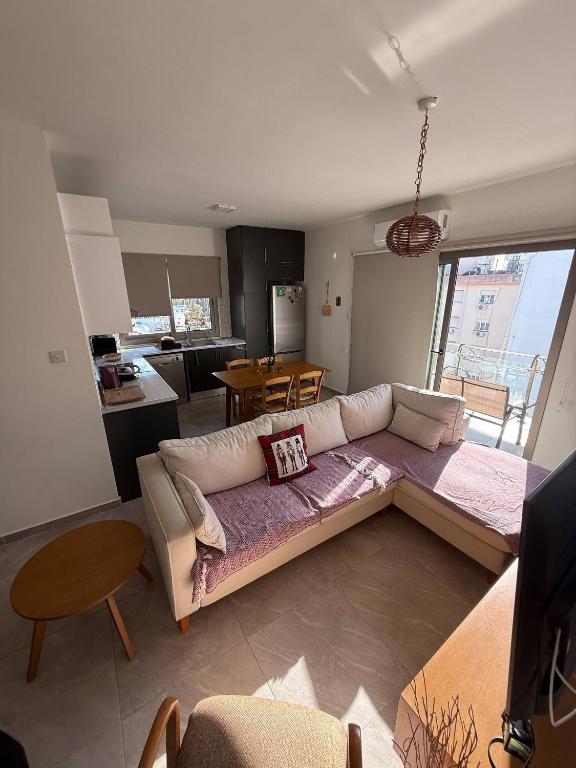 a living room with a couch and a kitchen at Central Nicosia Haven in Nicosia