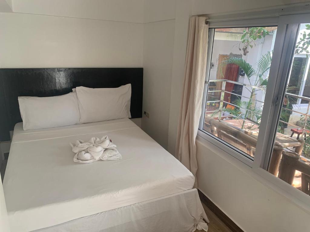 Postel nebo postele na pokoji v ubytování NVH4 Nanay Vacation Home Coron Palawan