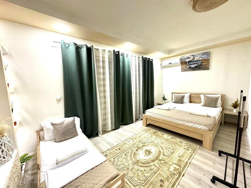 a living room with two beds and green curtains at LuxuryHomeUlcinj2 in Ulcinj