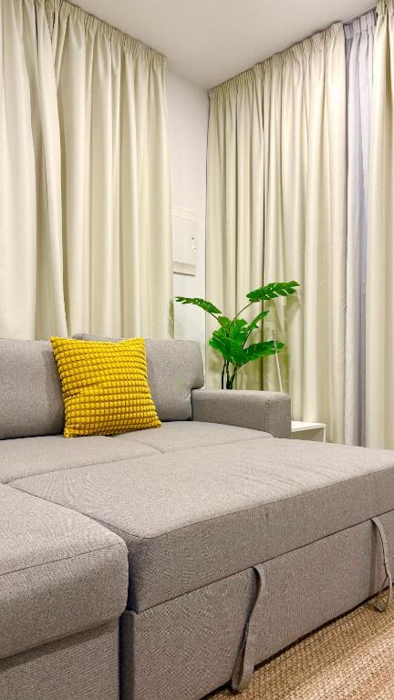 a living room with a couch and a plant at playa honda airport suite in Playa Honda
