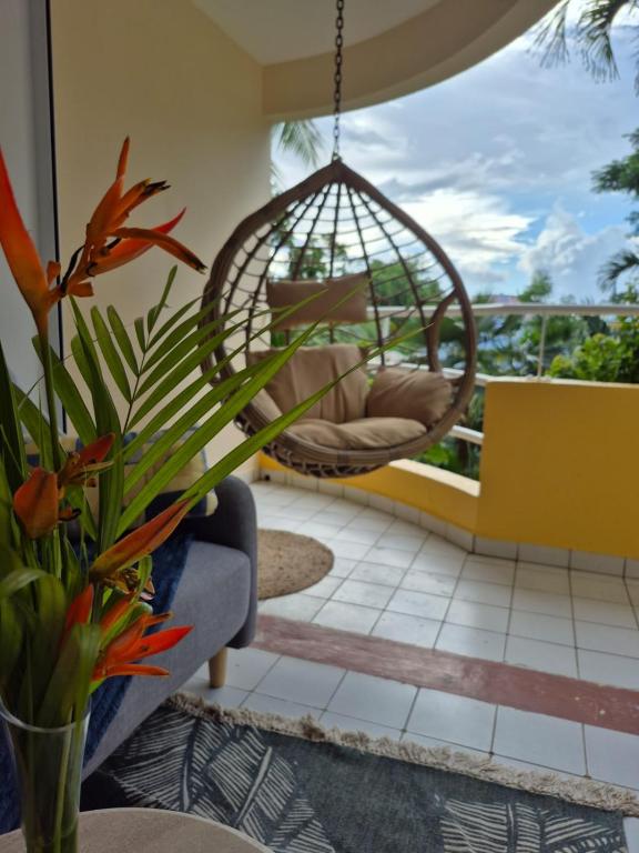 a hanging swing in a living room with at Kreyol Chic in Le Gosier