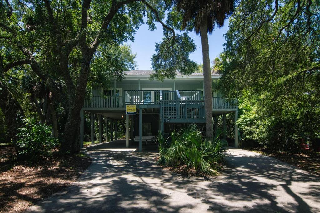 a house with a wrap around porch with trees at Miss Irene in Edisto Island