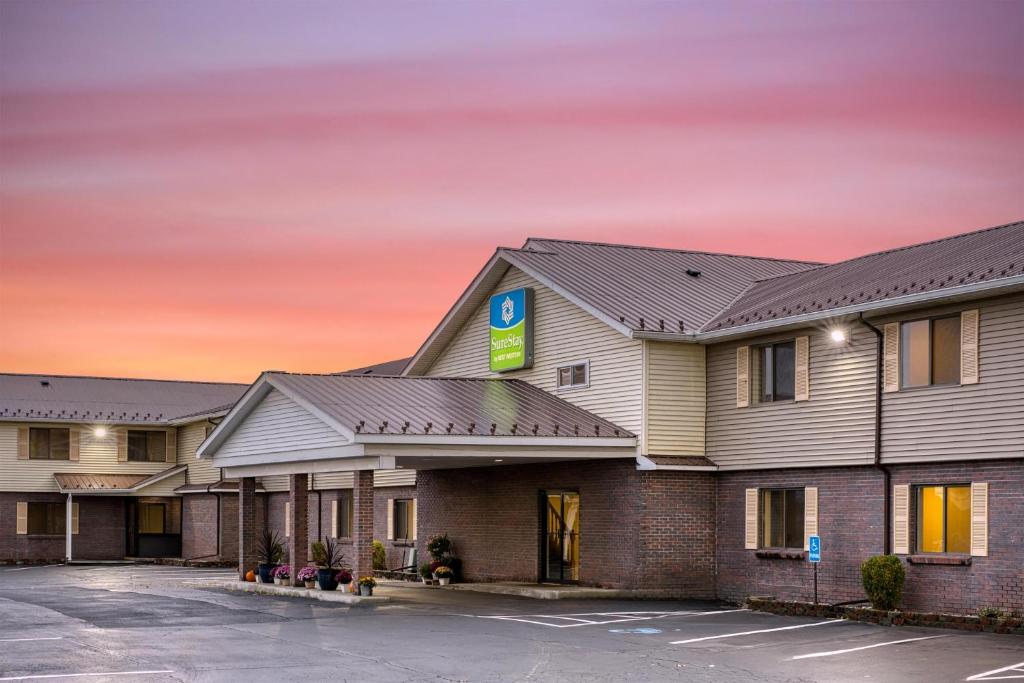 a rendering of a hotel with a parking lot at SureStay by Best Western Massena in Massena