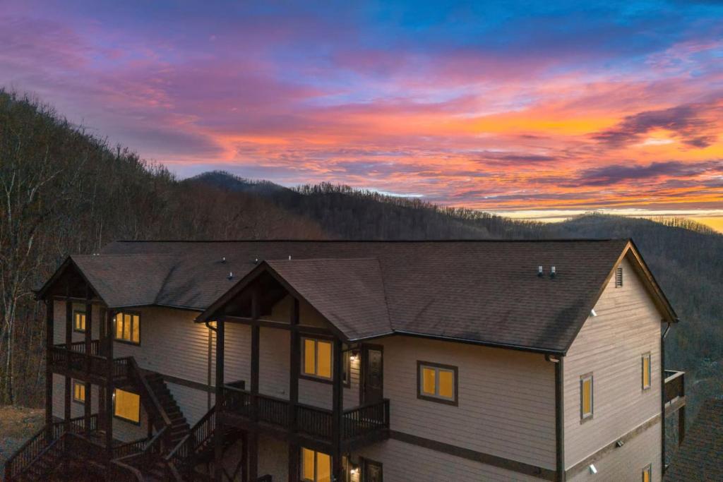 a house with a sunset in the mountains at Mountain View 4 Units - Mountain Retreat, 8BR, Views, Near Smokies in Cullowhee