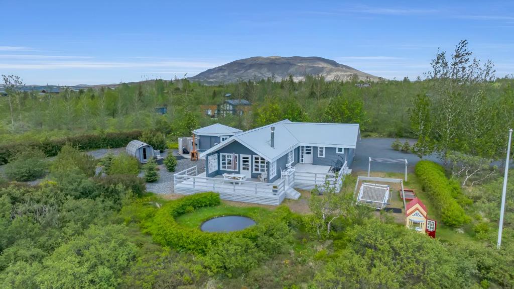 an aerial view of a house with a mountain in the background at Modern 4BR Summerhouse with Sauna and Hot Tub in Selfoss