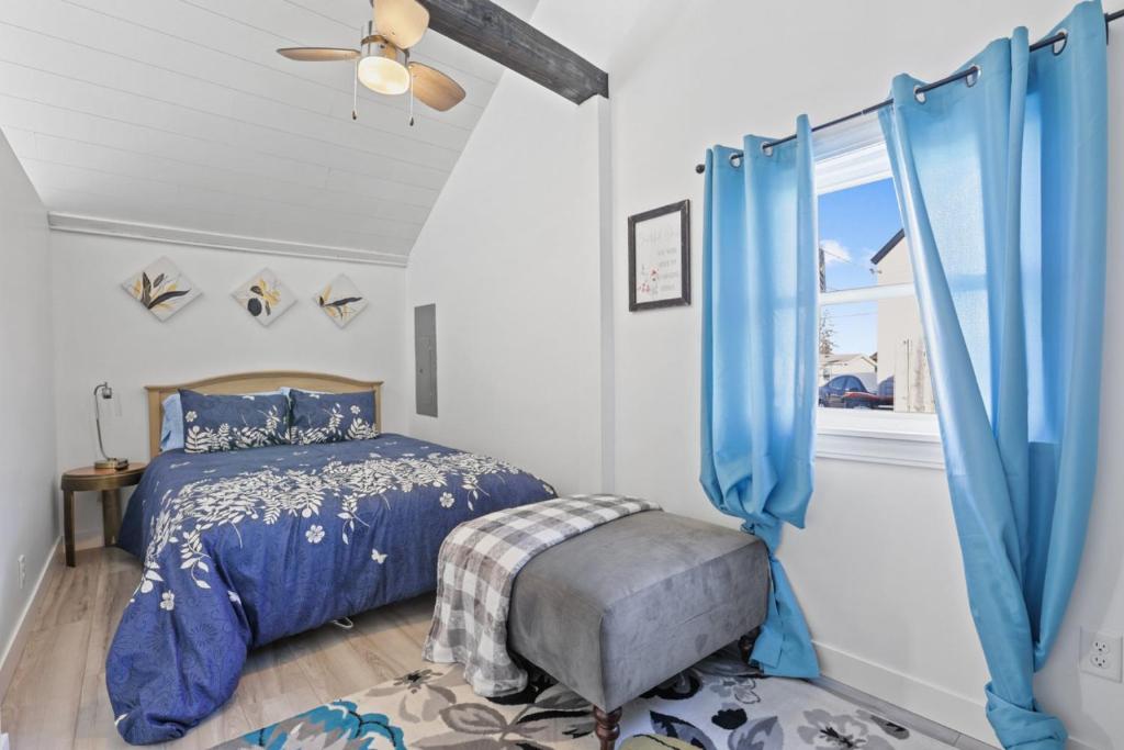 a bedroom with blue curtains and a bed and a window at The Shack in Buckeye Lake