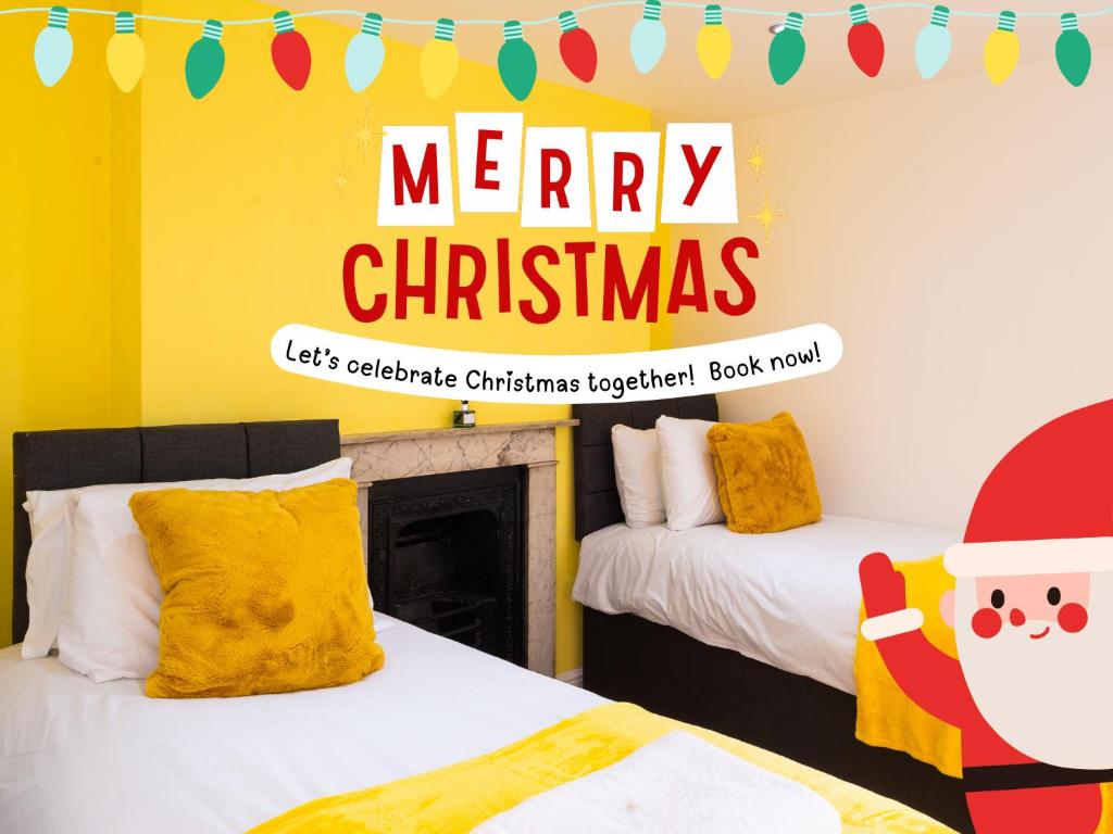 two beds in a room with a merry christmas sign at Cozy 2BR 2BATH Apt in Central Ipswich - Sleeps 6 & Prime Location in Ipswich
