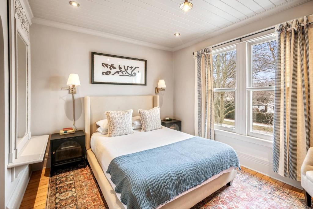a bedroom with a bed and a window at Guestroom in Old Town | Steps to Lake & Everything in Niagara on the Lake