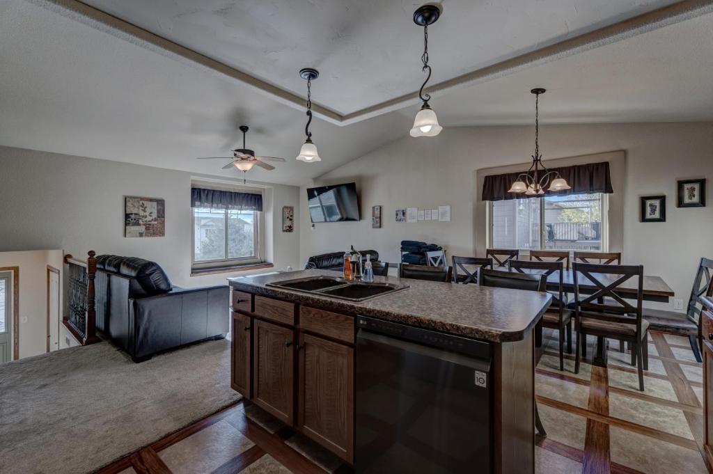 a kitchen and living room with a table and chairs at Just Like Home, Centrally Located Family Friendly! in Rapid City