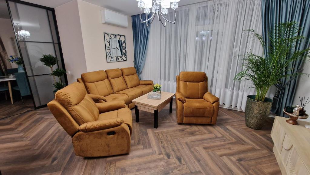 a living room with two chairs and a couch and a table at Audronašos apartamentai - self cheking- Gargžduose in Gargždai