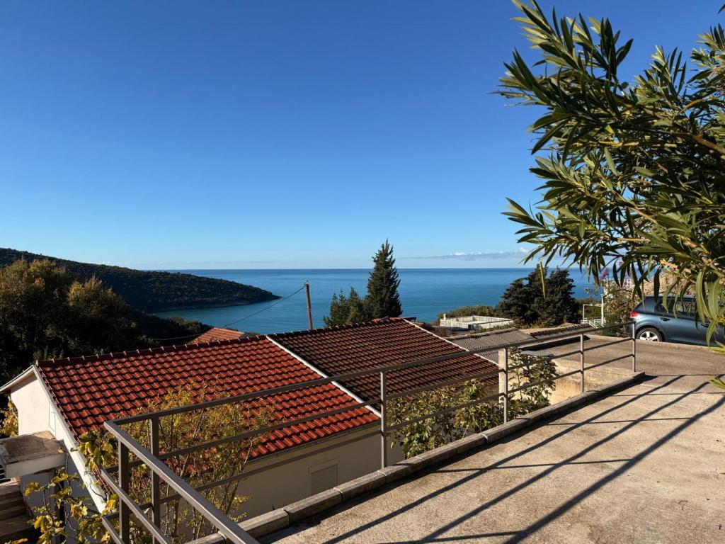 a view of a house with the ocean in the background at Summer house Kruce in Kruče