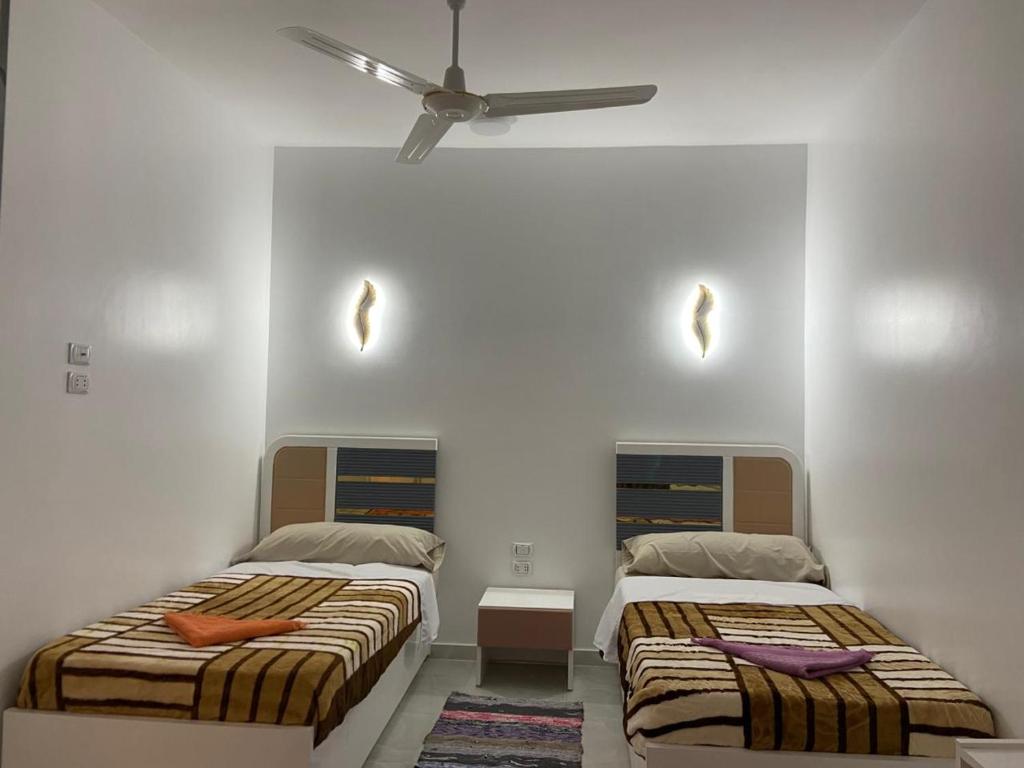 Ένα ή περισσότερα κρεβάτια σε δωμάτιο στο OBAI Nubian Guest House