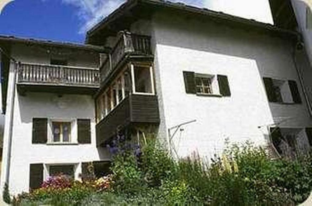 a large white house with a balcony on it at Cad Maté 2 in Maloja