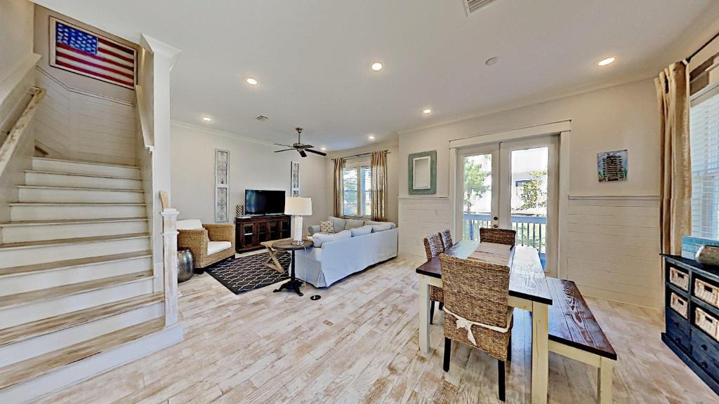 a living room with a staircase and a couch at Prominence 30A - Holiday House in Watersound Beach