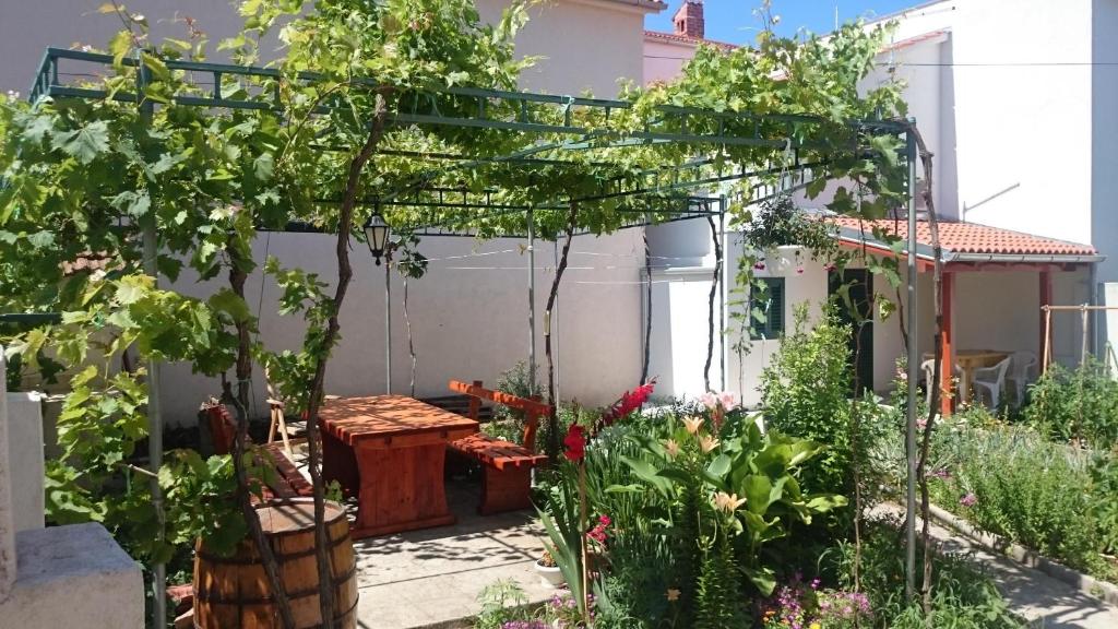 a garden with a pergola and some plants at Gemütliche Ferienwohnung Emil in Murter