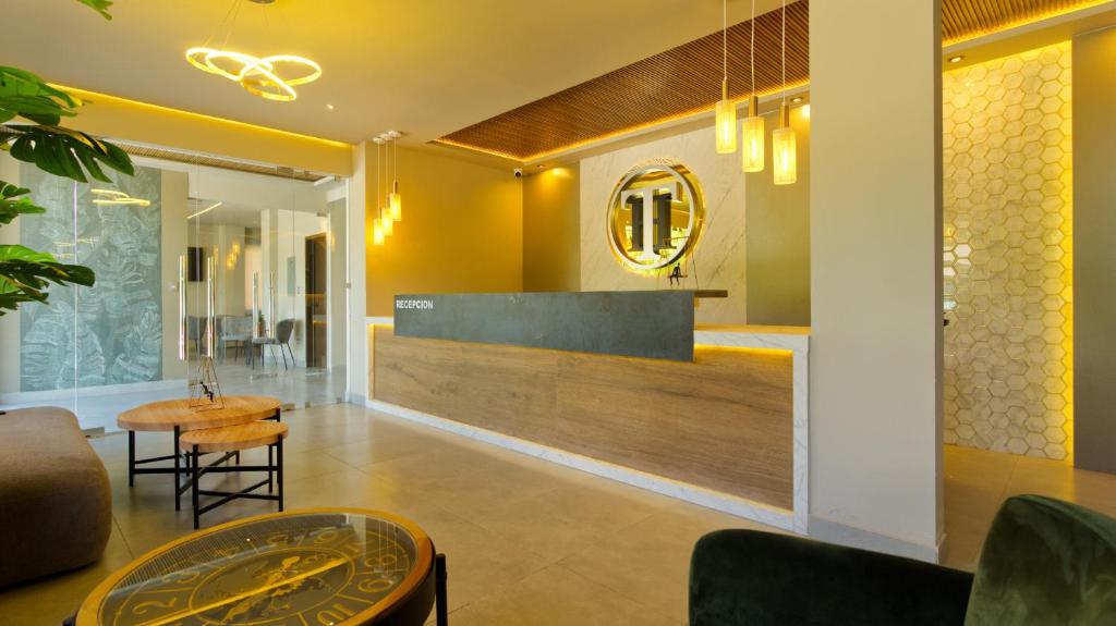 a lobby with a table and a mirror on the wall at Hotel Tiffany in Flores