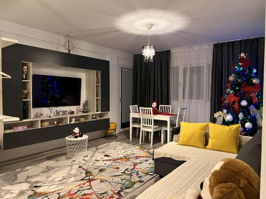 a living room with a christmas tree in the corner at Lapus Residence Apartament in Craiova