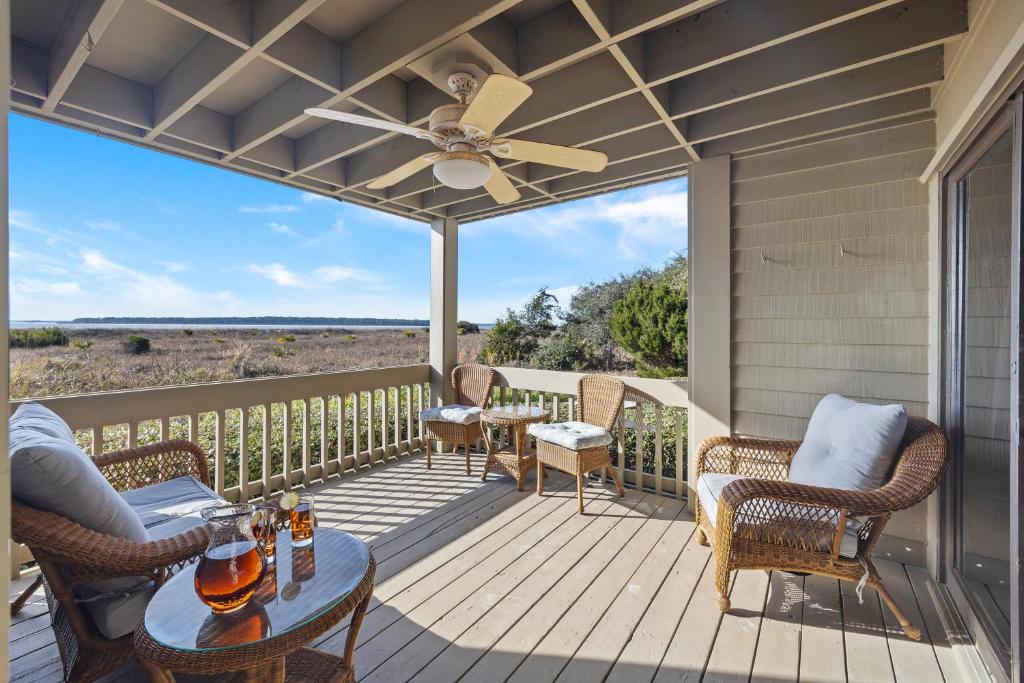 a porch with chairs and a ceiling fan at PW13103: 13103 Pelican Watch in Seabrook Island