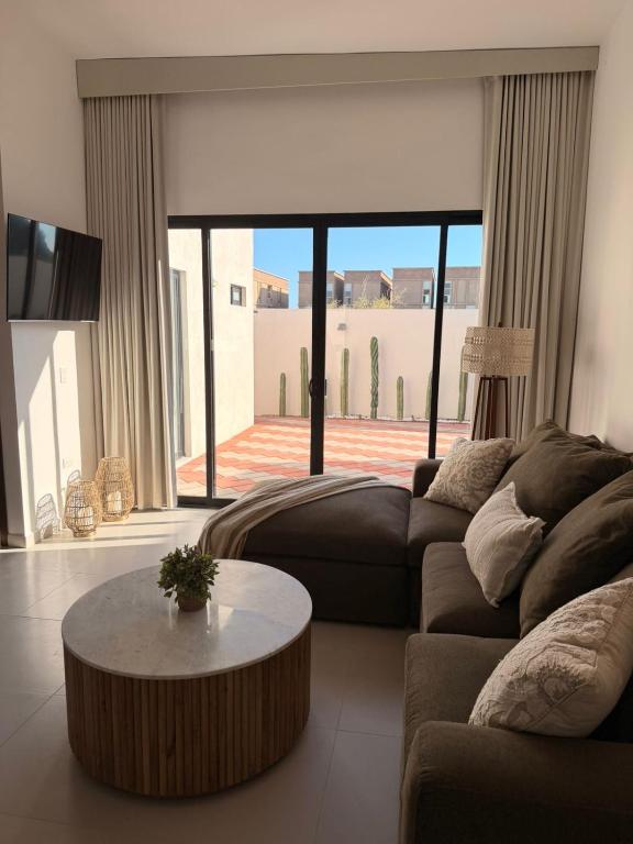 a living room with a couch and a coffee table at Modern beach house in San Carlos in San Carlos