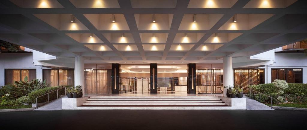 The covered lobby approach with broad steps and glass entrance doors.