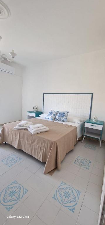 a bedroom with a large bed with two tables at Casa Marigé in San Nicola Arcella