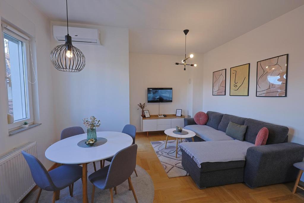 a living room with a couch and a table at Kosta Boutique Apartment in Banja Luka