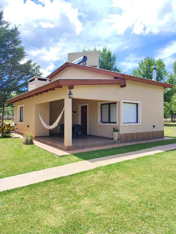 a small house with a hammock on top of it at Cabaña premium! in Villa Anizacate