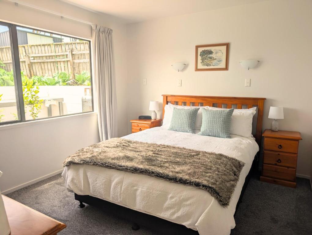 a bedroom with a large bed and a window at Topsy Turvey self-contained accommodation Mangonui in Mangonui
