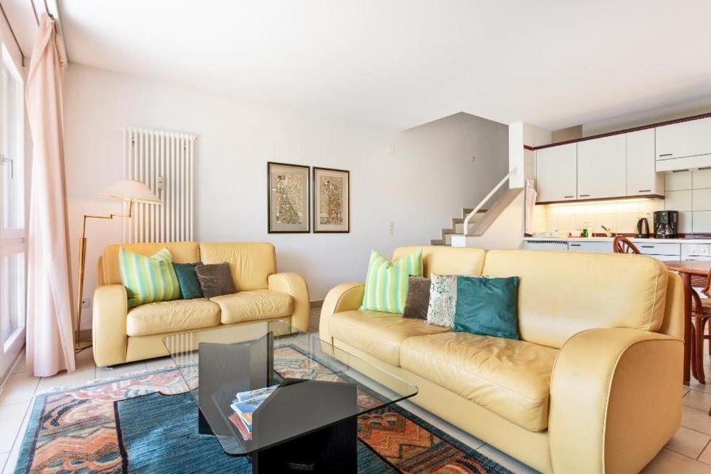 a living room with two couches and a table at Golf Ranch, 1Er Stock in Ascona