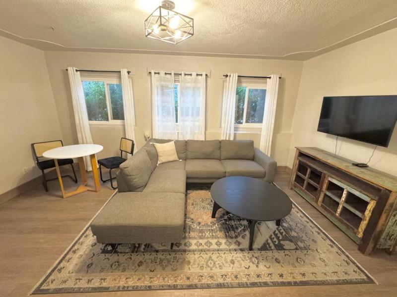 a living room with a couch and a table at Charming Yosemite Basecamp - Walk to Downtown in Mariposa