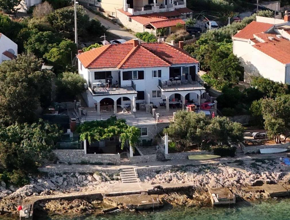 an aerial view of a house on the water at Apartments by the sea Maslinica, Solta - 774 in Grohote