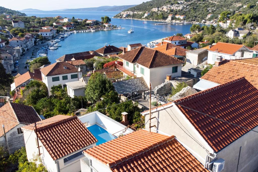 a view of a town with a river and houses at Seaside family friendly house with a swimming pool Drvenik Veliki, Drvenik - 22085 in Veliki Drvenik