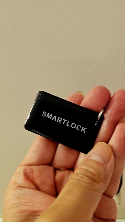 a person holding a small black object in their hand at NEW Bangsar Trade Centre KL Mid Valley LRT Bangsar in Kuala Lumpur