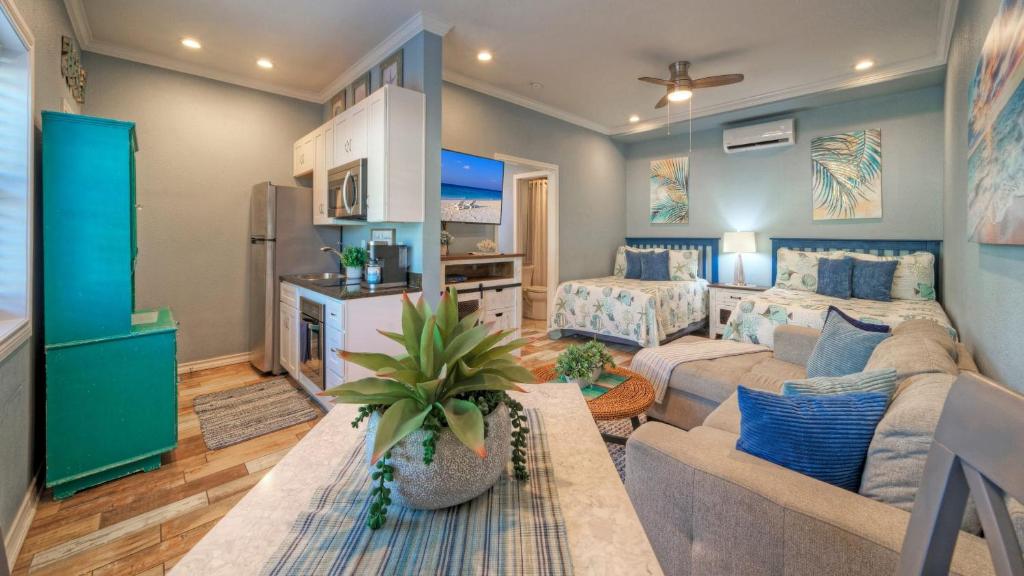 a living room with a couch and a table at 2 Pools Beach Boardwalk Access Studio Sleeps 5 Beach Bungalow by AvantStay in Port Aransas