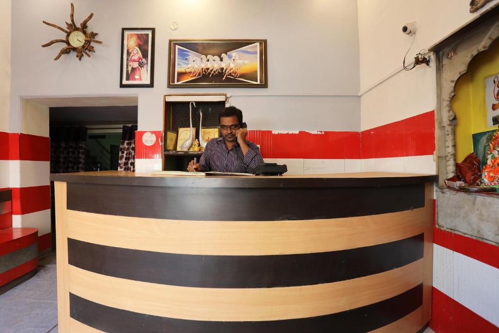 a man sitting at a bar in a restaurant at Hotel O Vanshika in Agra